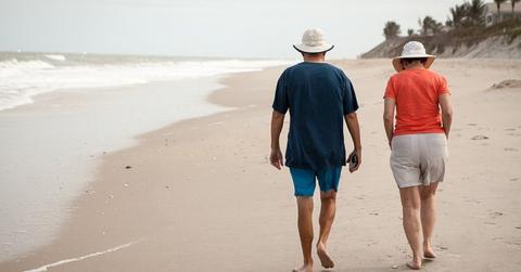 Older couple walking on the beach
