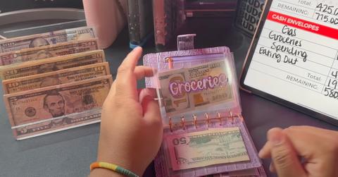 A person cash stuffing using envelopes.