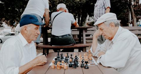 Two older men playing chess