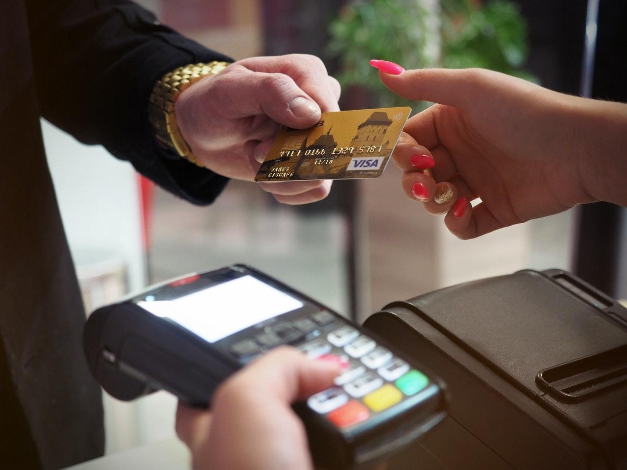 A person using a credit card at a shop