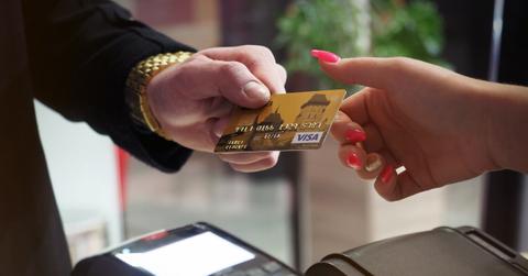 A person using a credit card at a shop