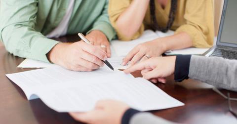 Couple signing loan documents