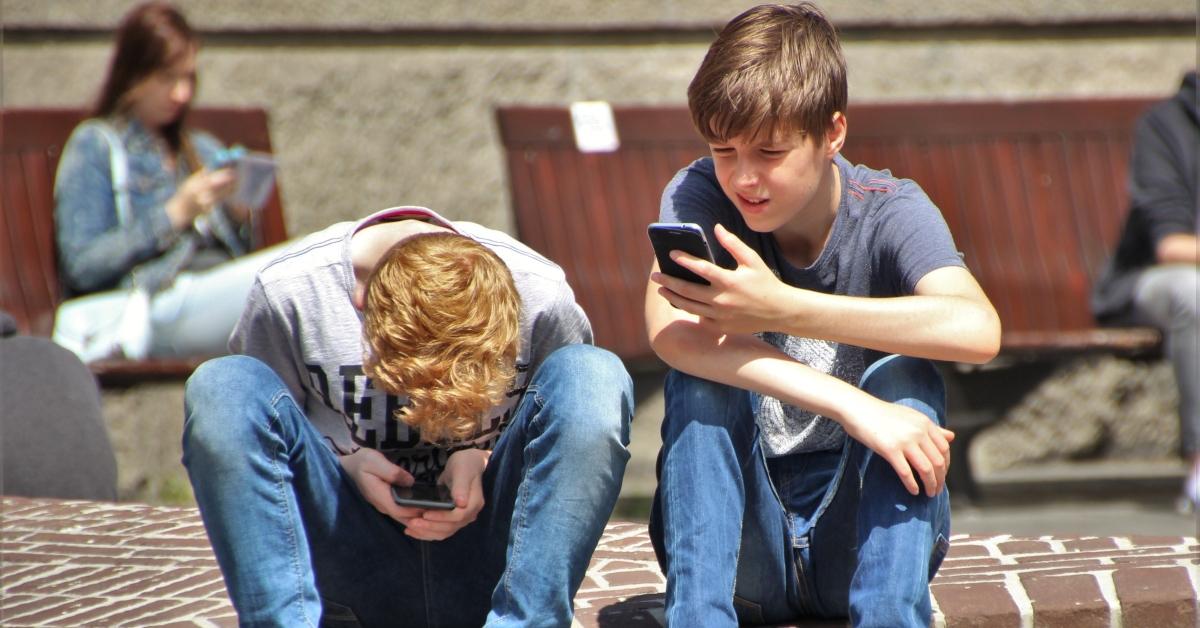 Teenagers looking at their cellphones