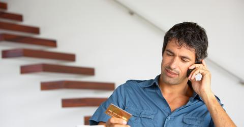 A man holding a credit card