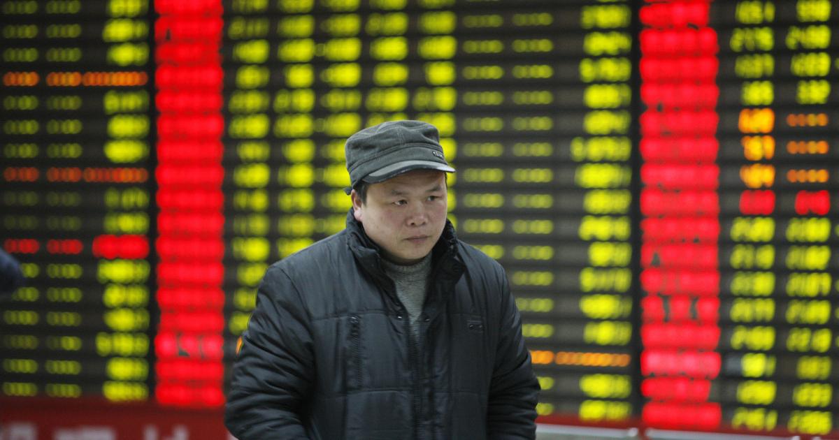 Person walking with Chinese stock tickers in background