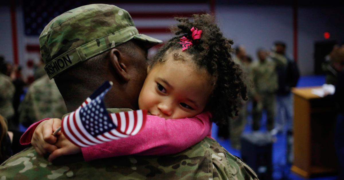 U.S. Army soldier hugging daughter