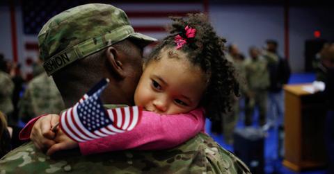 U.S. Army soldier hugging daughter
