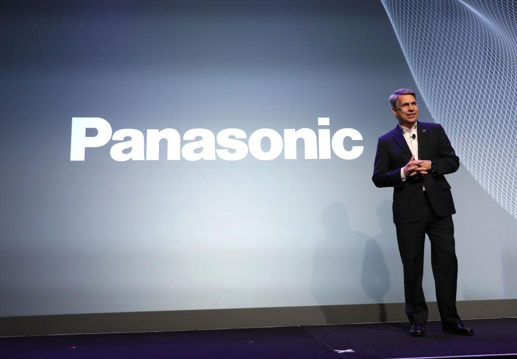 A person standing in from of the Panasonic logo