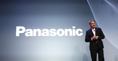 A person standing in from of the Panasonic logo