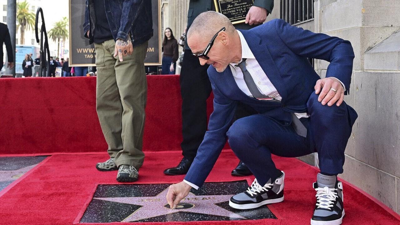 Robert Downey Jr. putting chewing gum on a Hollywood Star
