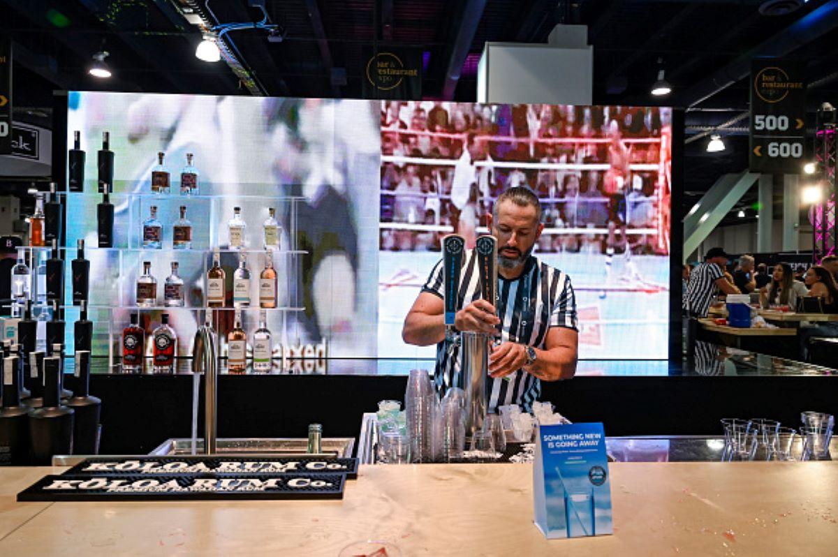 A bartender pours a beer behind a bar