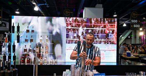A bartender pours a beer behind a bar