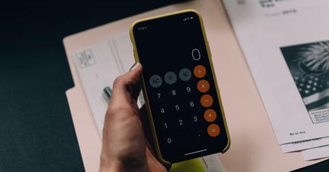 Person using a calculator for tax-loss harvesting