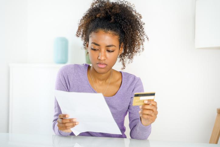 A frustrated woman reading a bill