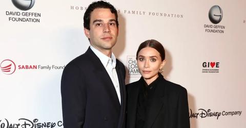 Louis Eisner and Ashley Olsen pose together in black at event.