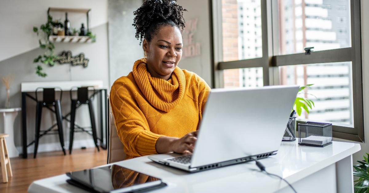 A woman using a refurbished laptop