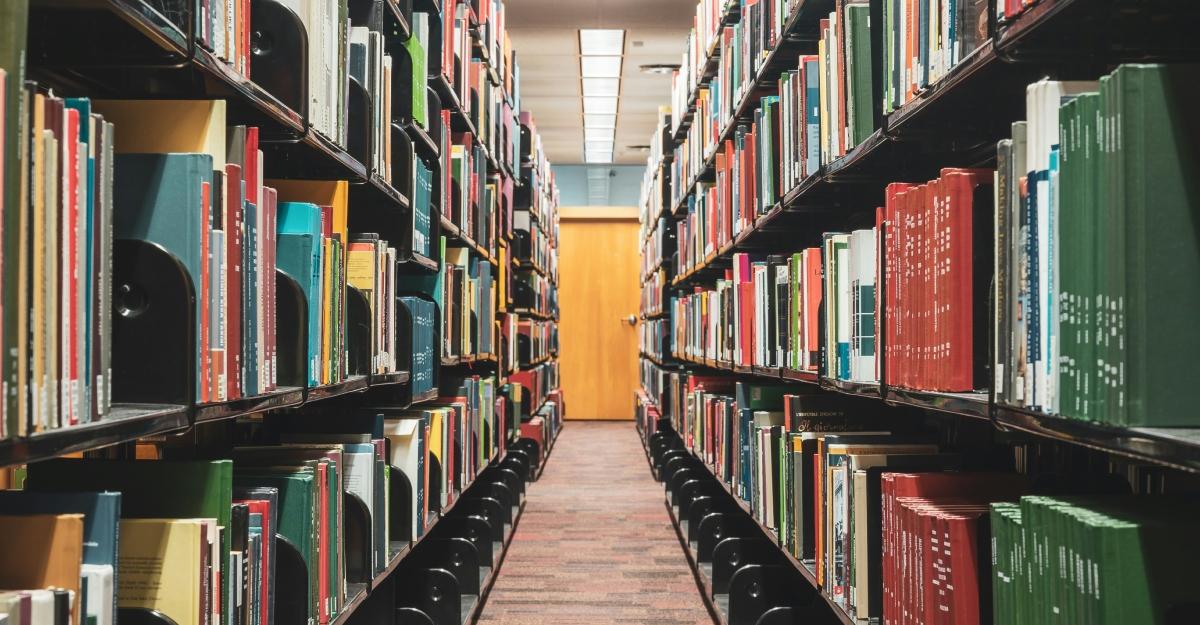 Books line shelves in a college library.