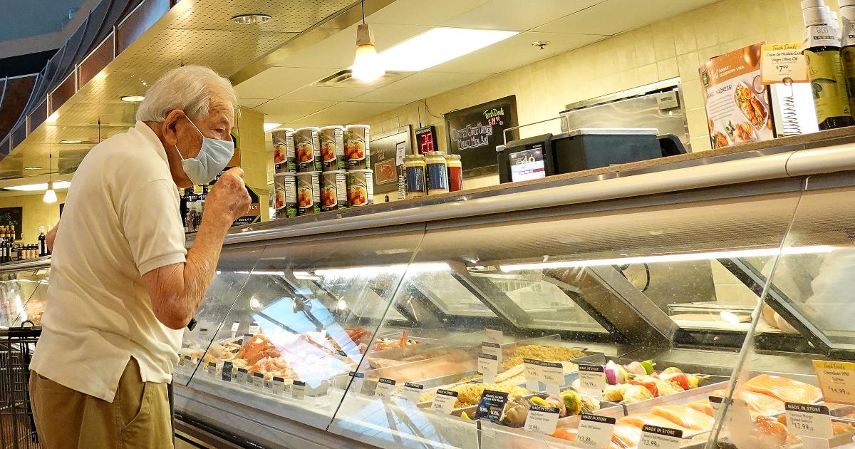 Person looks at food prices amid high inflation