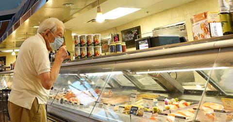 Person looks at food prices amid high inflation