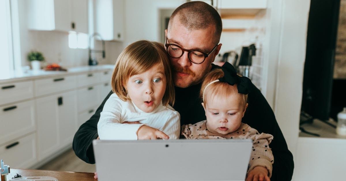 Parent playing on his tablet with his kids