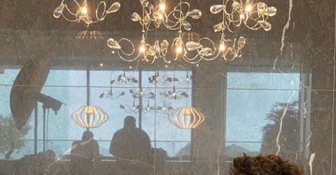 Dan Bilzerian sitting with his company’s perfume line for men