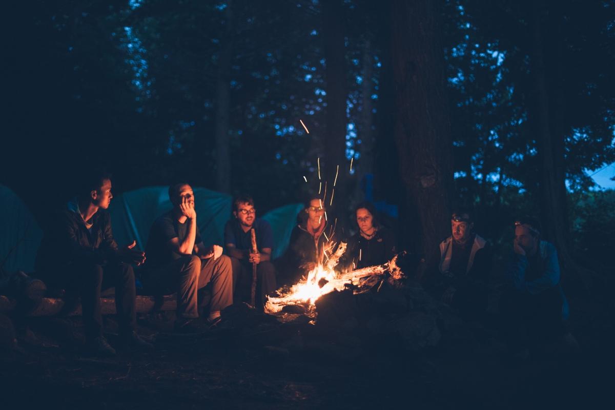 Teens at a bonfire in the woods