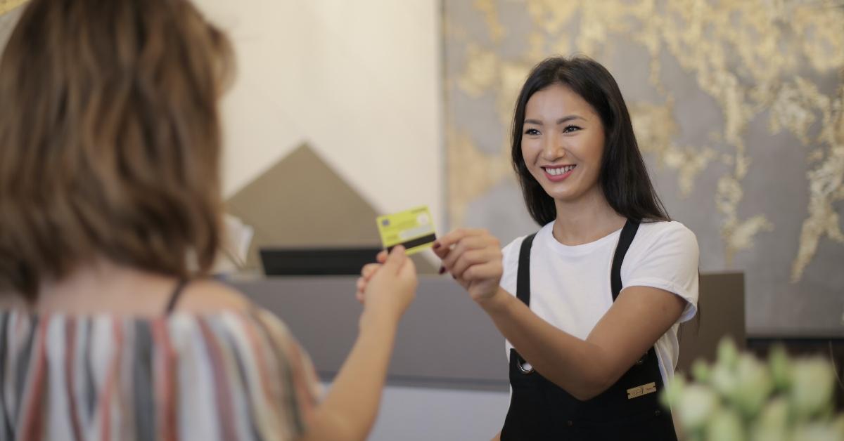 A woman is making a purchase with a credit card