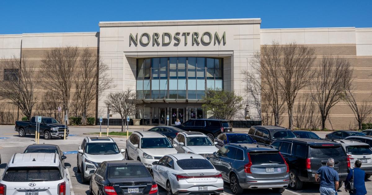 Several cars parked in front of Nordstrom in parking lot in Austin, Texas.