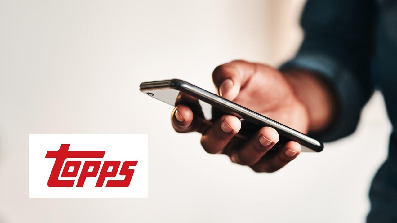 Man using a smartphone and Topps logo