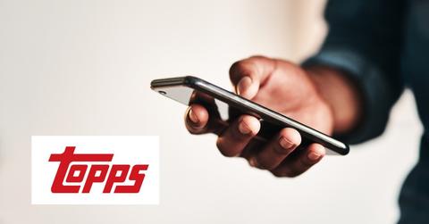 Man using a smartphone and Topps logo