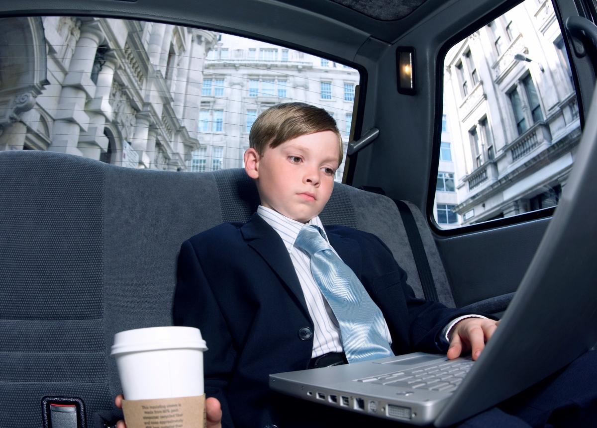 A young boy in a suit for 'Take Your Child to Work Day'