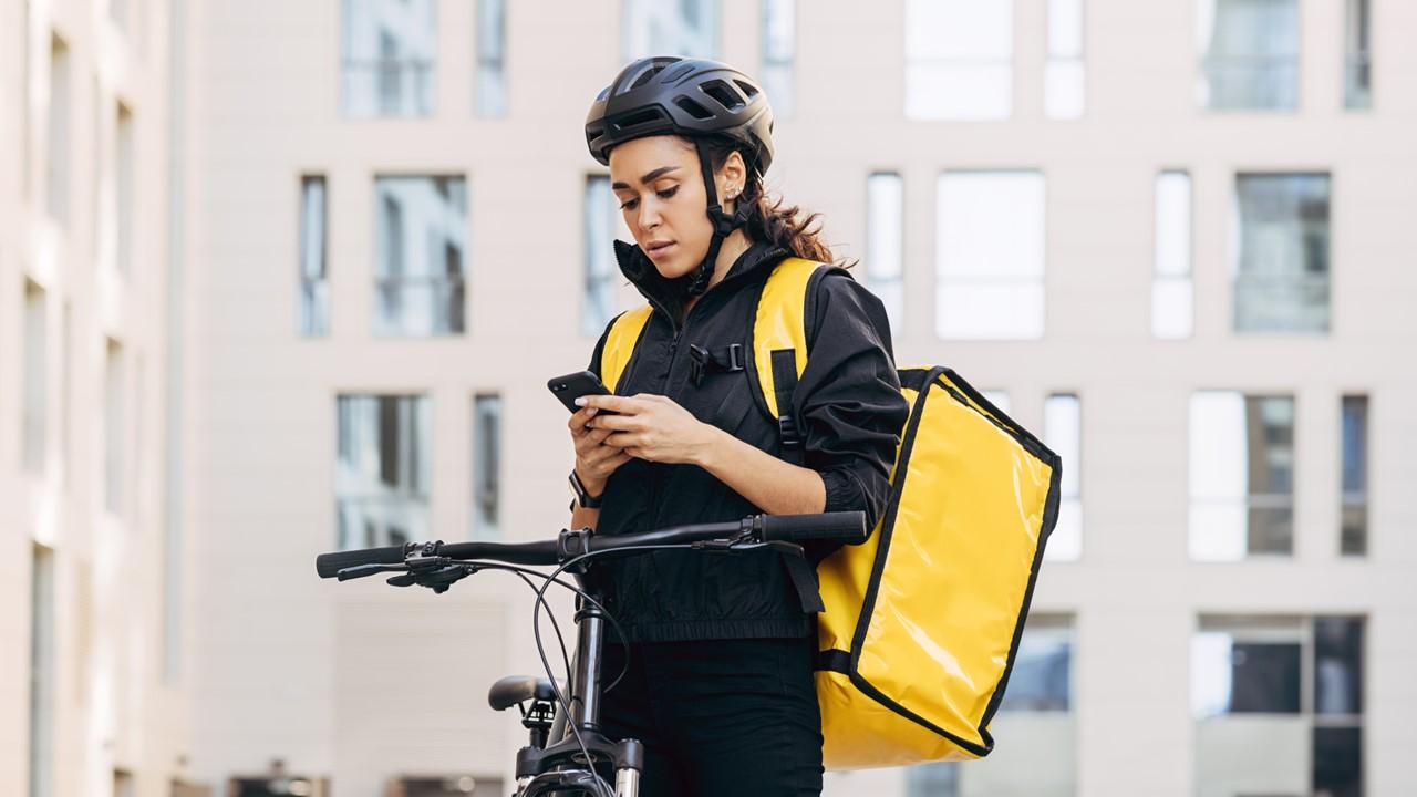 A female food delivery worker on a bicycle