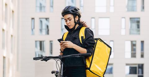 A female food delivery worker on a bicycle