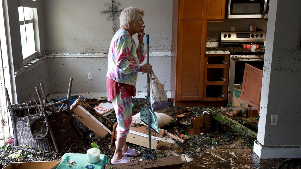 A woman in a flooded home
