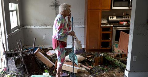A woman in a flooded home