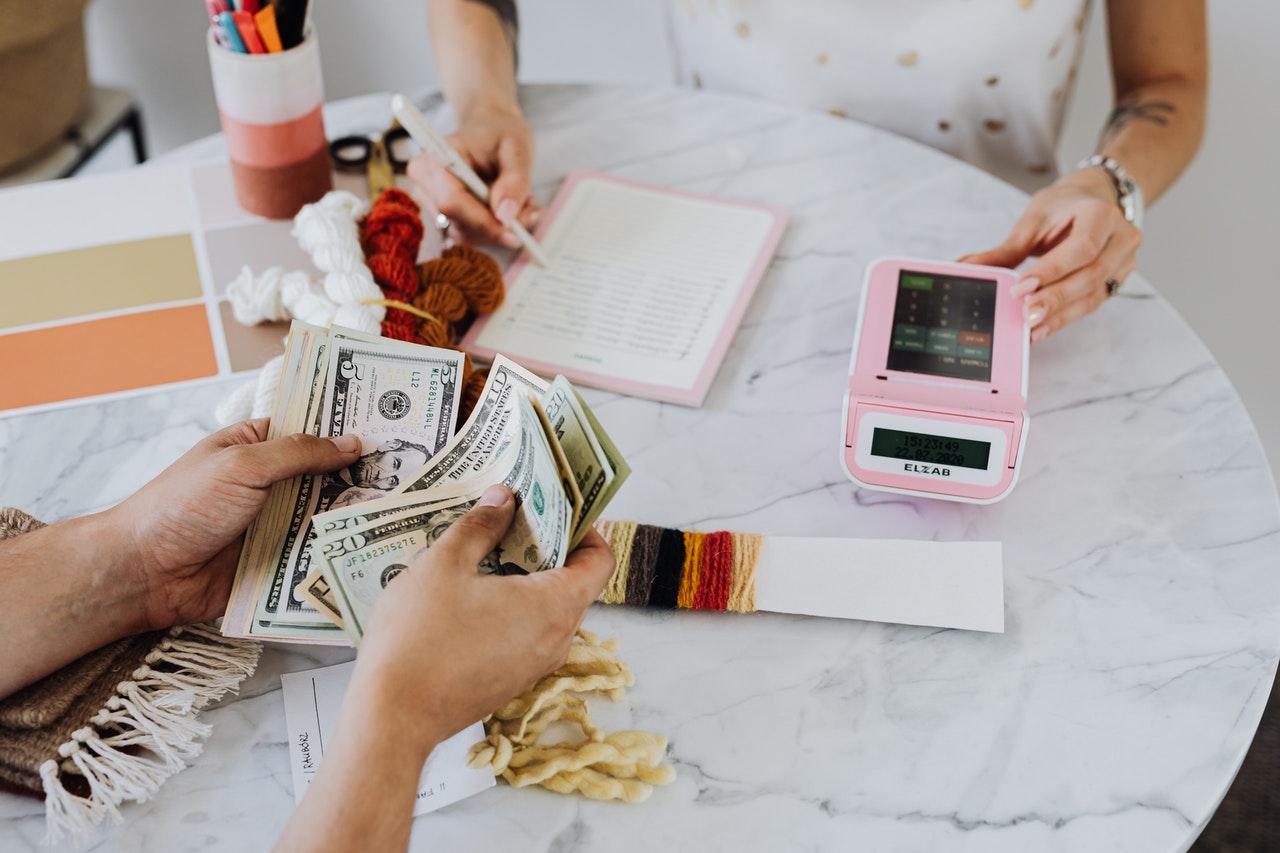 Hands holding U.S. dollar bills