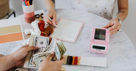 Hands holding U.S. dollar bills
