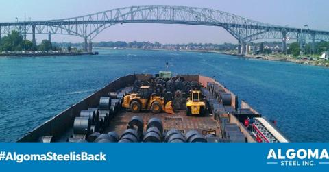 A barge carrying steel on a river