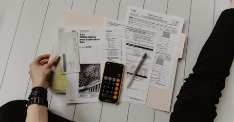 A person completing tax paperwork