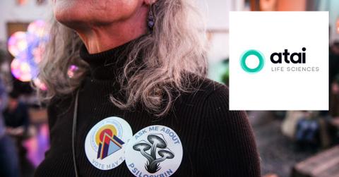 Woman wearing badges and ATAI logo