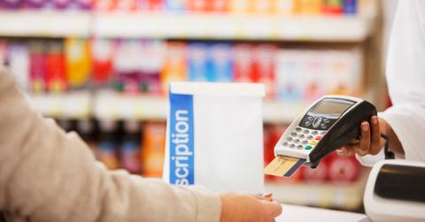 A person paying for drugs at a pharmacy