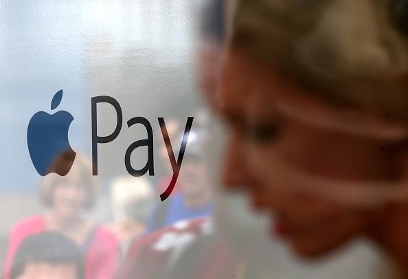 Apple Pay logo and woman's silhouette