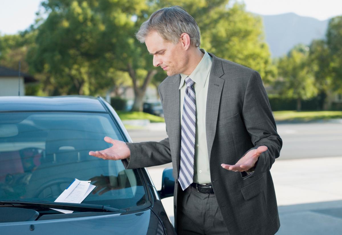 A man getting a parking ticket