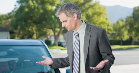 A man getting a parking ticket