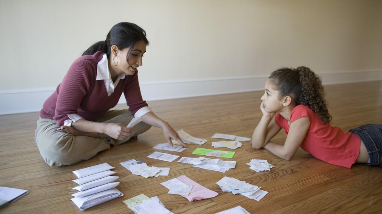 A woman looking at bills