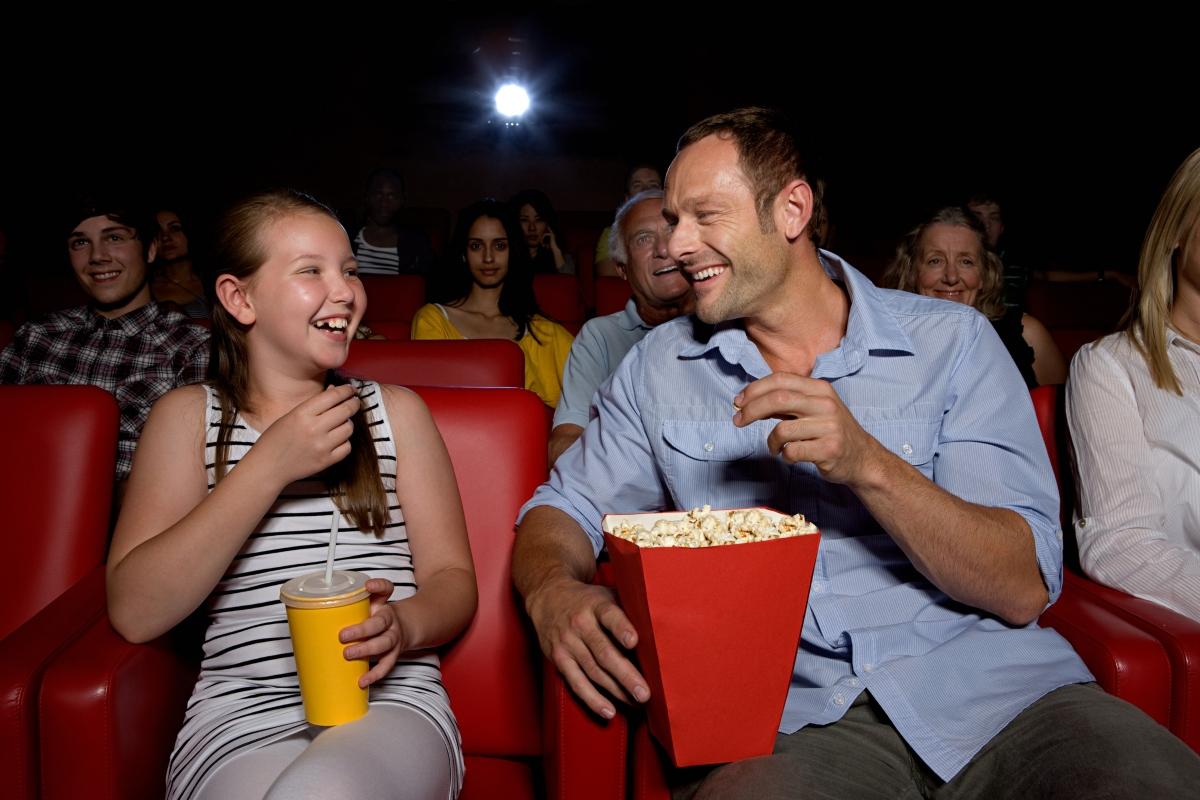 People eating popcorn at a movie theater