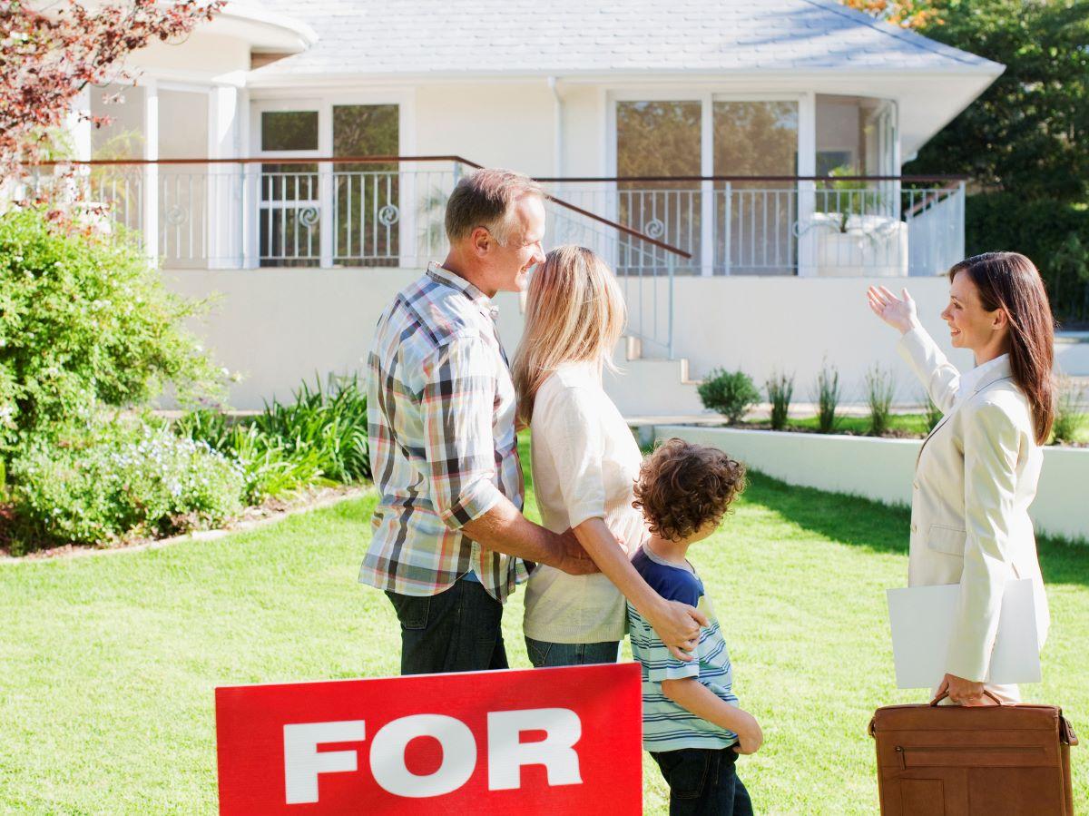 Female realtor showing a house for sale