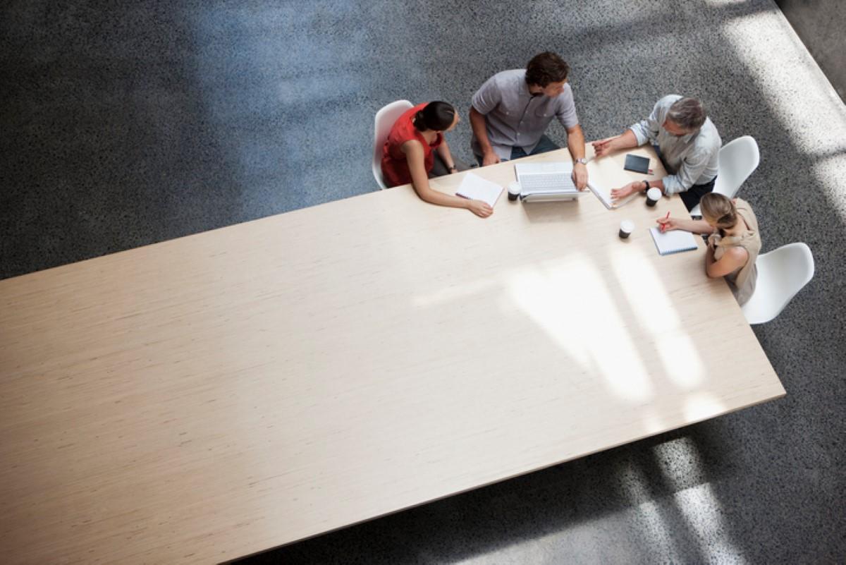 Coworkers sitting around a conference table in the office