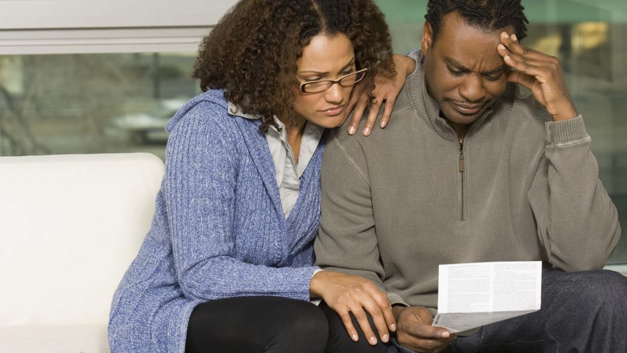 A couple looking at junk fees on a bill