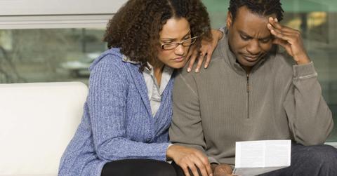 A couple looking at junk fees on a bill